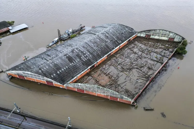 Aerial view of a warehouse destroyed by flooding in the port area of Porto Alegre, Rio Grande do Sul state, Brazil, taken on May 19, 2024. Porto Alegre, the Brazilian metropolis left submerged after torrential rains, had been lulled into a "false sense" of security by a vast but aging system of flood defenses, an urban drainage engineer told AFP. Leomar Teichmann said a network of dikes, levees and a massive wall was meant to protect about 40 percent of the capital city of Rio Grande do Sul state in southern Brazil, where 150 people have died and hundreds of thousands were forced from their homes. (Photo by Nelson ALMEIDA / AFP) (Nelson ALMEIDA/AFP Photo)