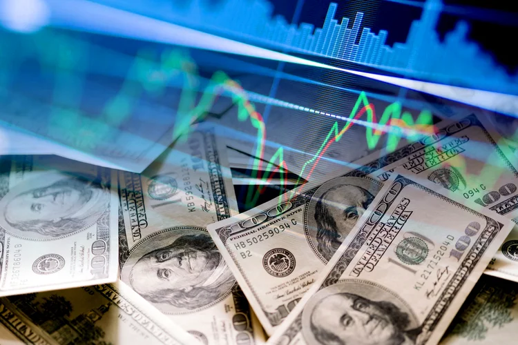 Cash dollar bills and stock market indicators (economy, money, business, finance, crisis, success, devaluation, inflation) (Javier Ghersi/Getty Images)