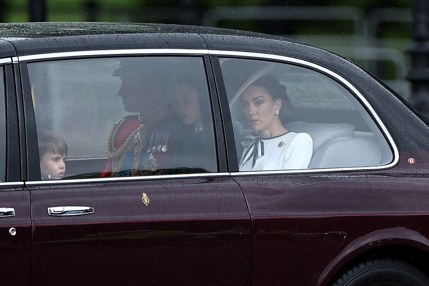 Britain's Catherine, Princess of Wales, (R) arrives with Britain's Prince William, Prince of Wales, (rear C) and their children Britain's Prince George of Wales (C) and Britain's Prince Louis of Wales (L) to Buckingham Palace before the King's Birthday Parade "Trooping the Colour" in London on June 15, 2024. The ceremony of Trooping the Colour is believed to have first been performed during the reign of King Charles II. Since 1748, the Trooping of the Colour has marked the official birthday of the British Sovereign. Over 1500 parading soldiers and almost 300 horses take part in the event. (Photo by HENRY NICHOLLS / AFP)