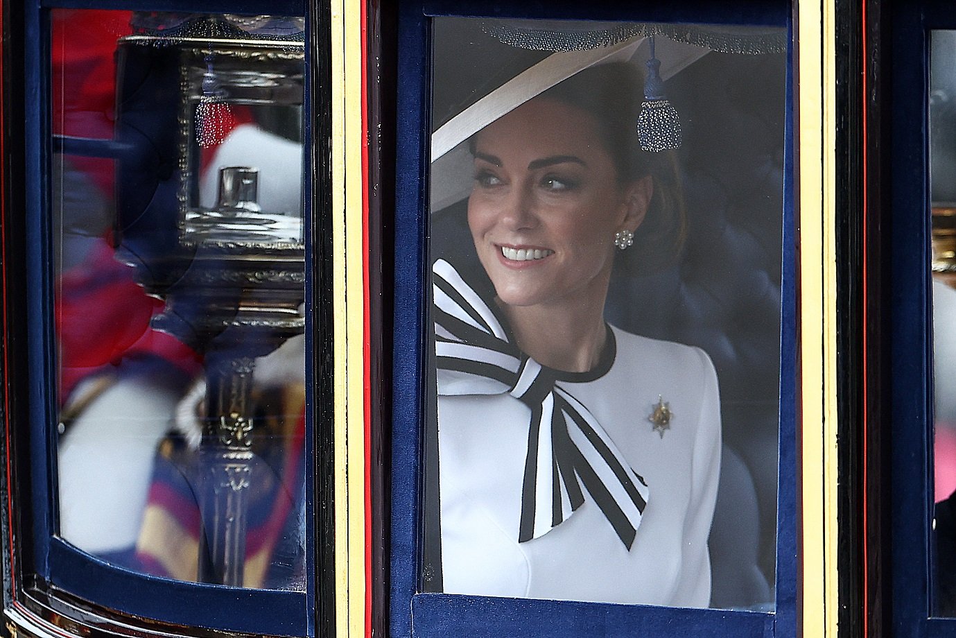 Britain's Catherine, Princess of Wales, smiles inside the Glass State Coach on her way to Horse Guards Parade for the King's Birthday Parade 