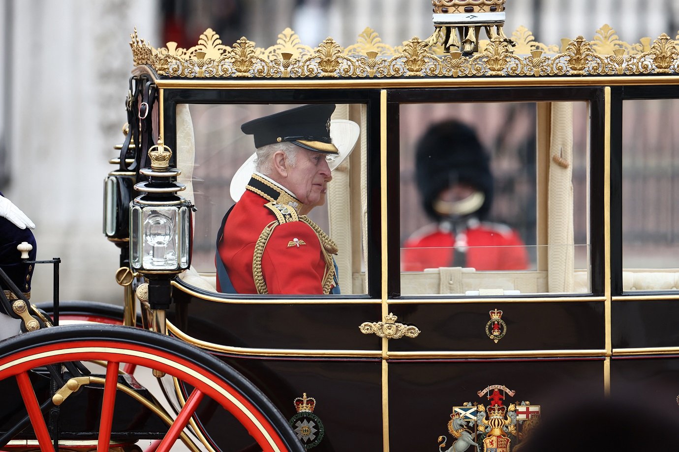 Britain's King Charles III sits inside the Scottish State Coach on his way to Horse Guards Parade for the King's Birthday Parade "Trooping the Colour" in London on June 15, 2024. (Photo by HENRY NICHOLLS / AFP)