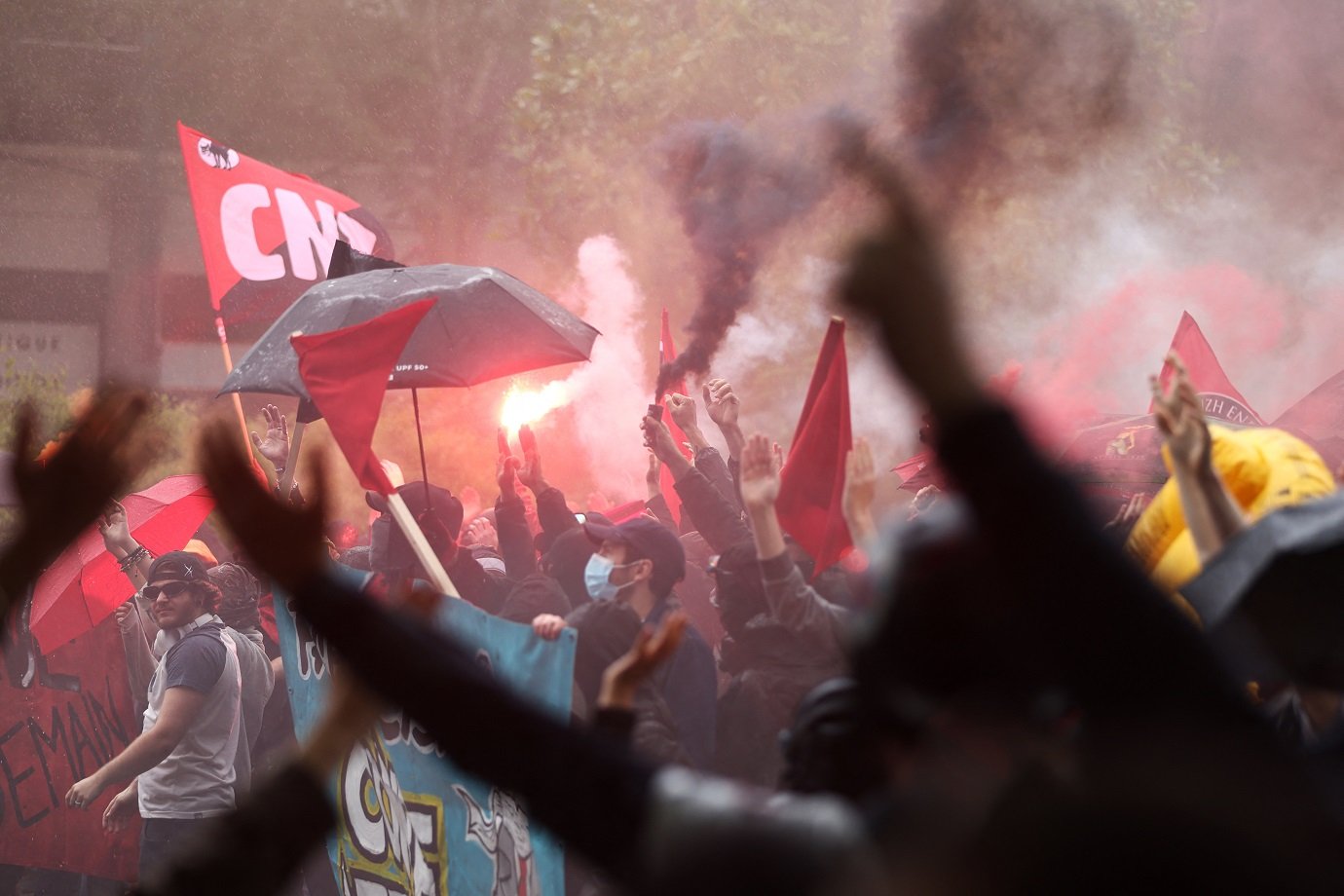 Demonstrators chant slogans and hold smoke flares during an anti far-right rally after the French president called legislative elections following far-right parties' significant gains in European Parliament elections, in Nantes on June 15, 2024. Less than a week after the earthquake of the dissolution, opponents of the far-right are called by trade unions, associations and the left-wing coalition of the "Nouveau Front Populaire" to take to the streets across France. (Photo by ROMAIN PERROCHEAU / AFP)