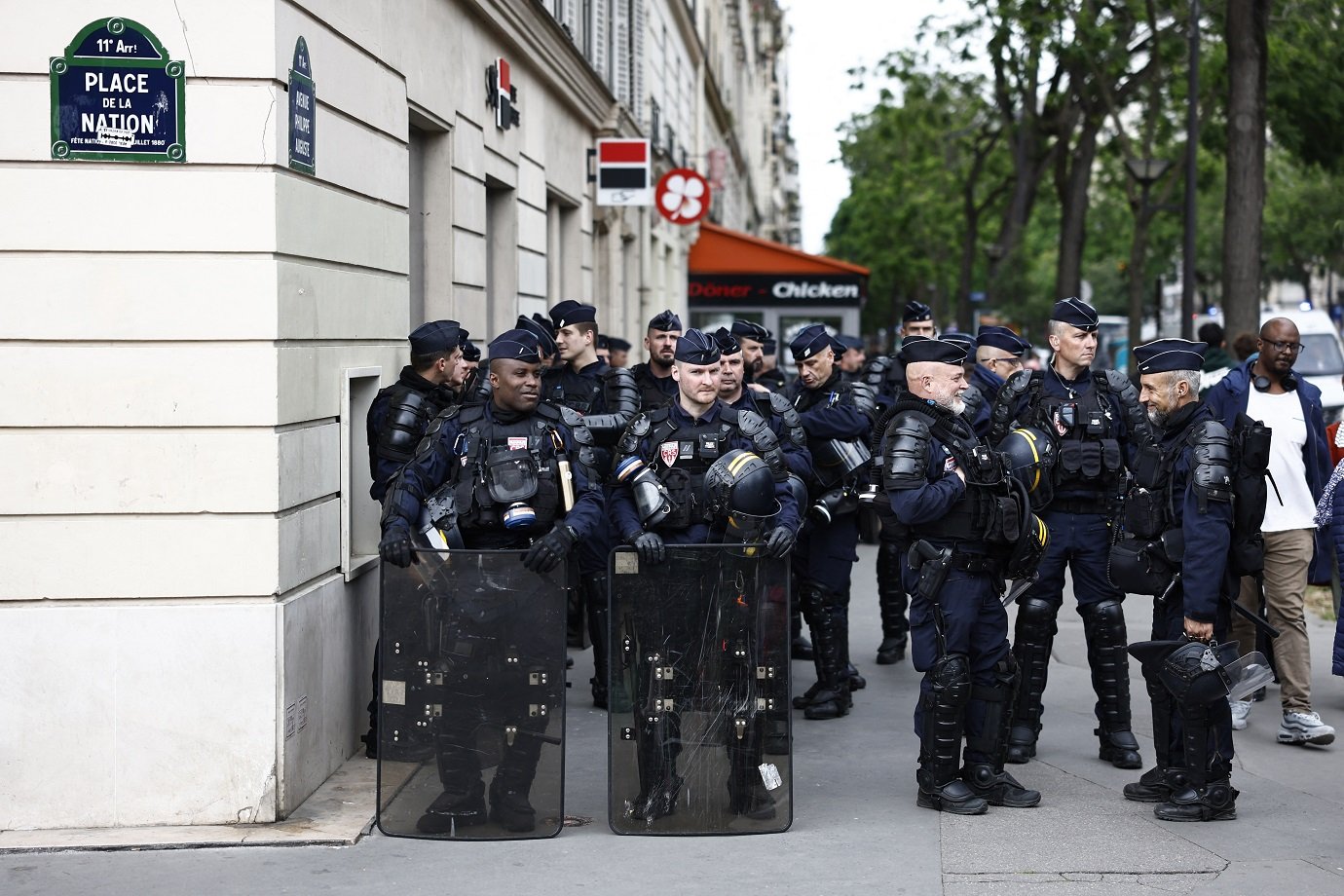 French Republican Security Corps (CRS) riot police officers stand guard near Place de la Nation during an anti far-right rally after French president called legislative elections following far-right parties' significant gains in European Parliament elections, in Paris on June 15, 2024. Less than a week after the earthquake of the dissolution, opponents of the far-right are called by trade unions, associations and the left-wing coalition of the "Nouveau Front Populaire" to take to the streets across France. (Photo by Sameer Al-Doumy / AFP)