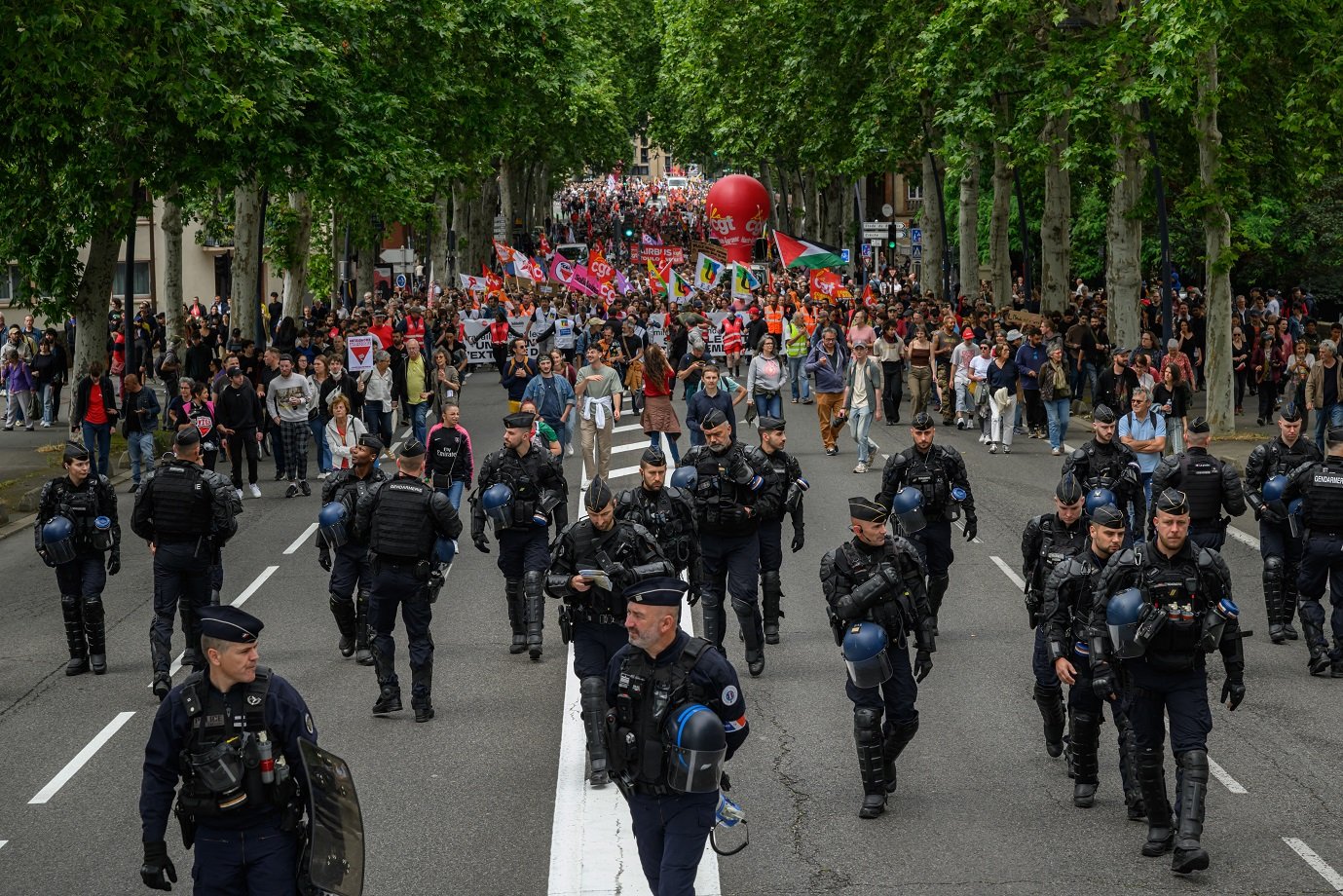 Anti-riot police officers walk ahead of an anti far-right rally after French president called legislative elections following far-right parties' significant gains in European Parliament elections, in Toulouse on June 15, 2024. Less than a week after the earthquake of the dissolution, opponents of the far-right are called by trade unions, associations and the left-wing coalition of the 