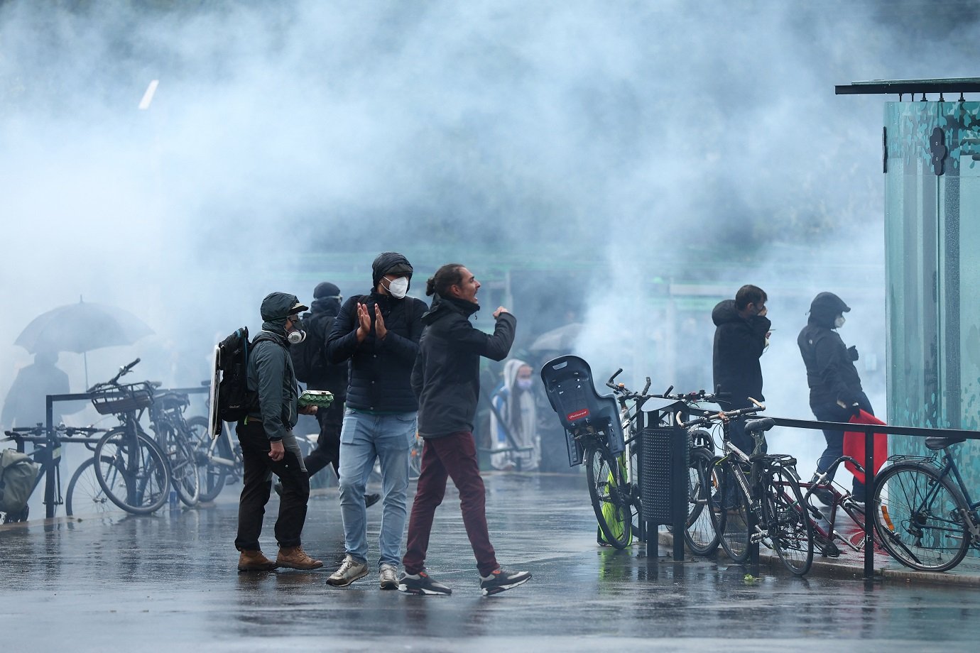 Protester stand in clouds of tear gas during a demonstration against the far right, in Nantes, western France, on June 15, 2024. Less than a week after the earthquake of the dissolution, opponents of the far-right are called by trade unions, associations and the left-wing coalition of the "Nouveau Front Populaire" to take to the streets across France after the French President called legislative elections following far-right parties' significant gains in European Parliament elections. (Photo by ROMAIN PERROCHEAU / AFP)