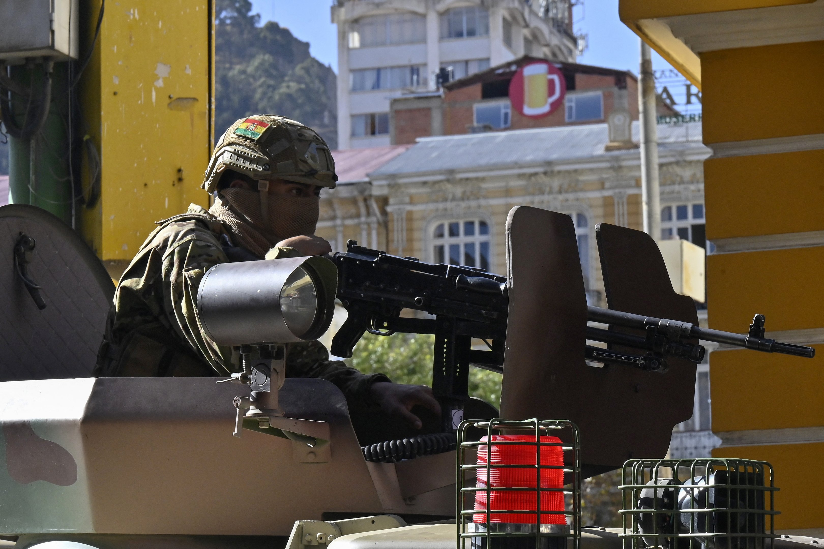 A soldier in an armored vehicle is deployed outside the Quemado Palace at the Plaza de Armas in La Paz on June 26, 2024. Bolivian President Luis Arce on Wednesday denounced the unauthorized gathering of soldiers and tanks outside government buildings in the capital La Paz, saying 
