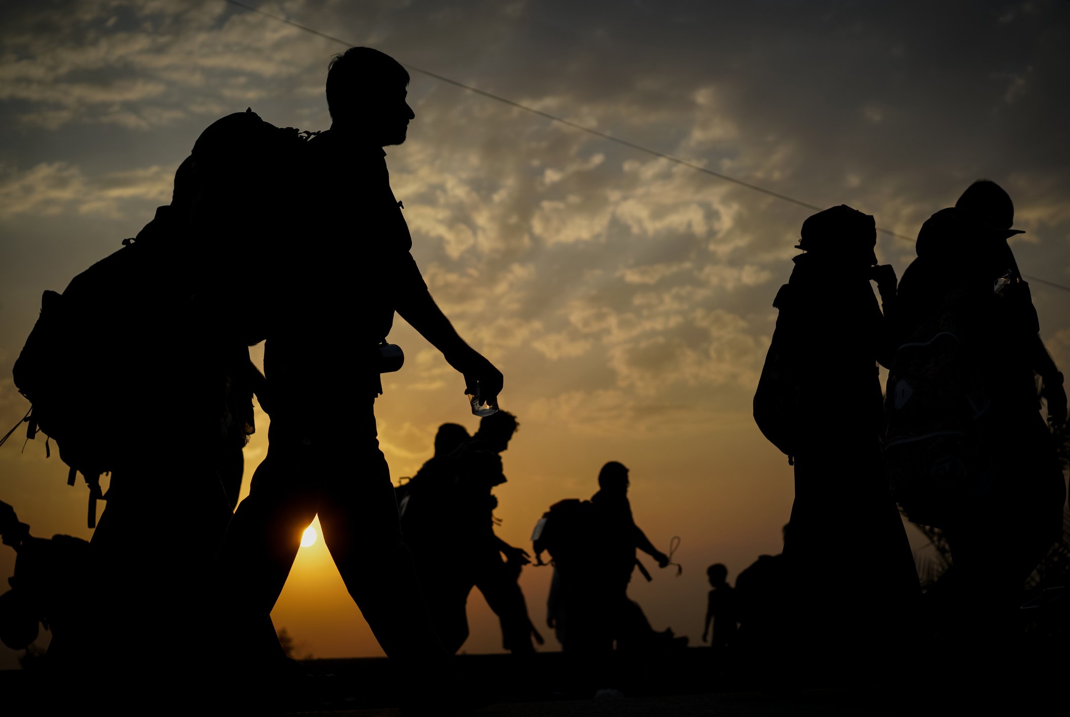 Immigrants walking before sunset