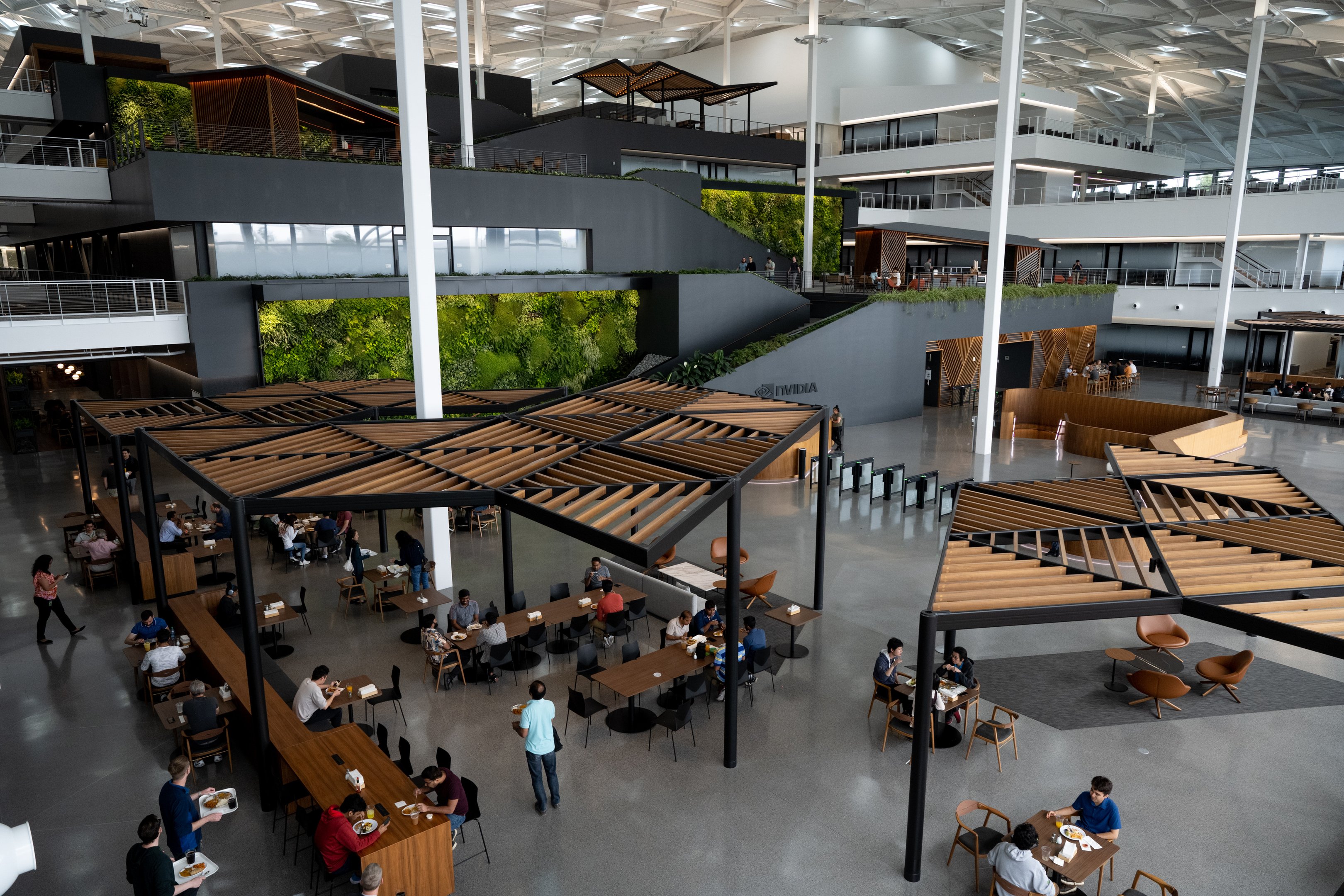 Employees inside the Voyager building at Nvidia headquarters in Santa Clara, California, US, on Monday, June 5, 2023. Nvidia Corp., suddenly at the core of the world's most important technology, owns 80% of the market for a particular kind of chip called a data-center accelerator, and the current wait time for one of its AI processors is eight months. Photographer: Marlena Sloss/Bloomberg via Getty Images