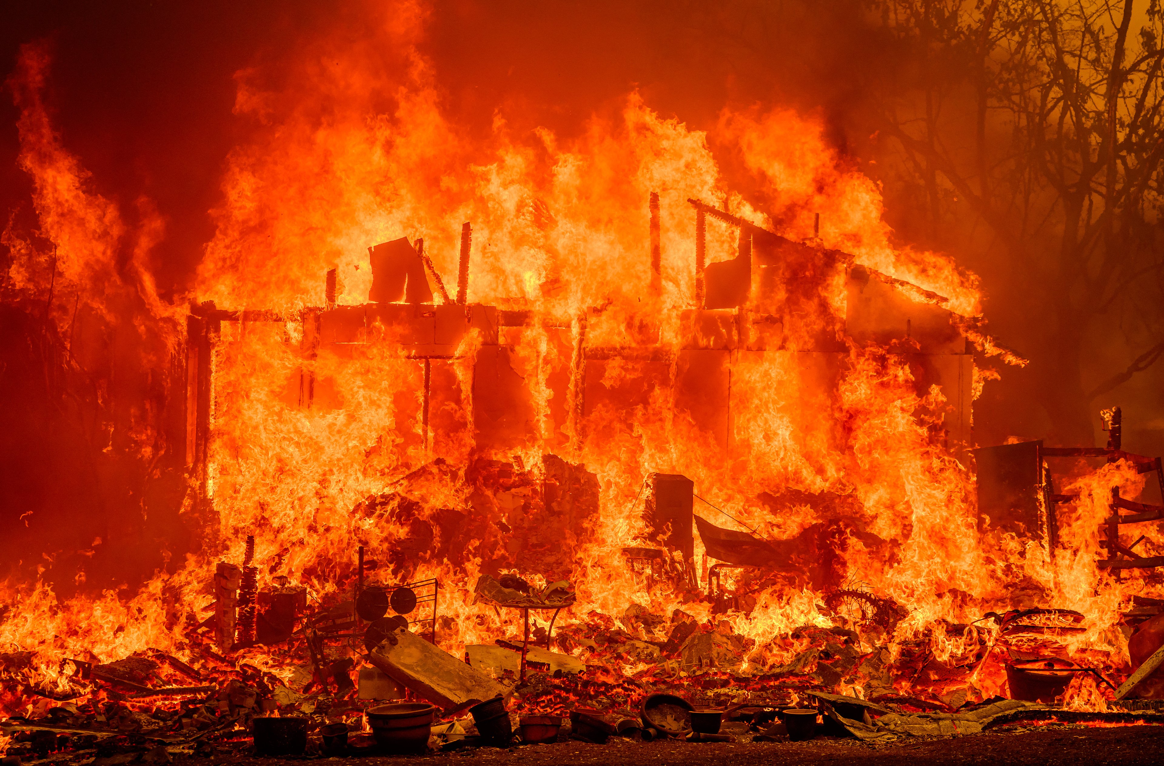 Flames engulf a home during the Thompson fire in Oroville, California on July 2, 2024. A heatwave is sending temperatures soaring resulting in red flag fire warnings throughout the state. (Photo by JOSH EDELSON / AFP)