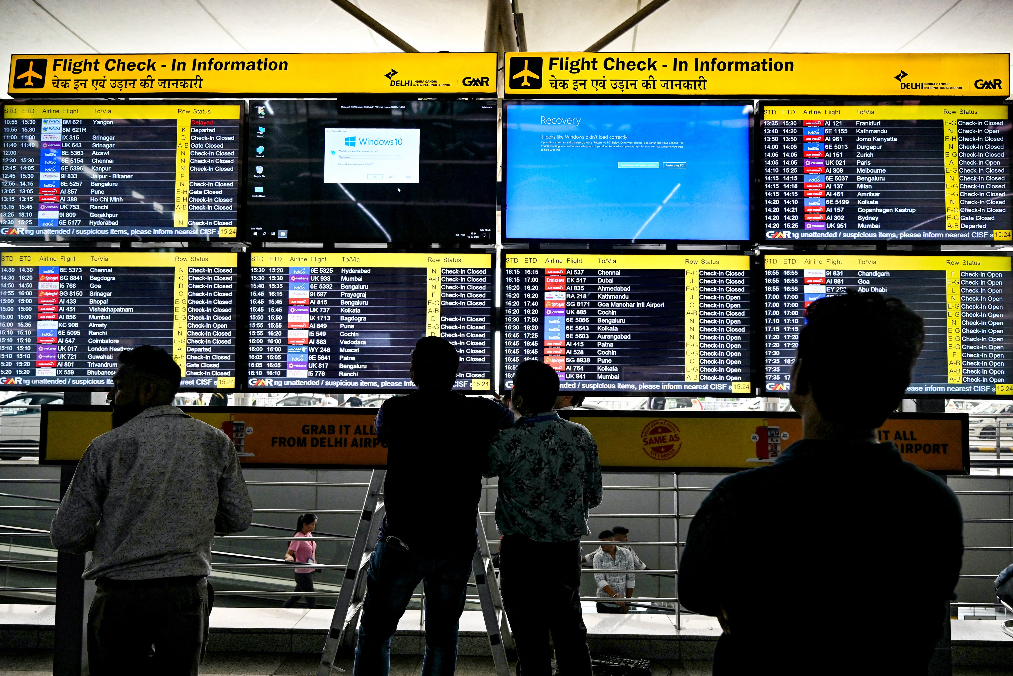 Display screens showing information on flights reflect error messages amid global IT outage at the Indira Gandhi International Airport in New Delhi on July 19, 2024. Five Indian airlines announced disruptions to their booking systems on July 19, matching widespread technical problems reported by flight operators around the world. (Photo by Money SHARMA / AFP)