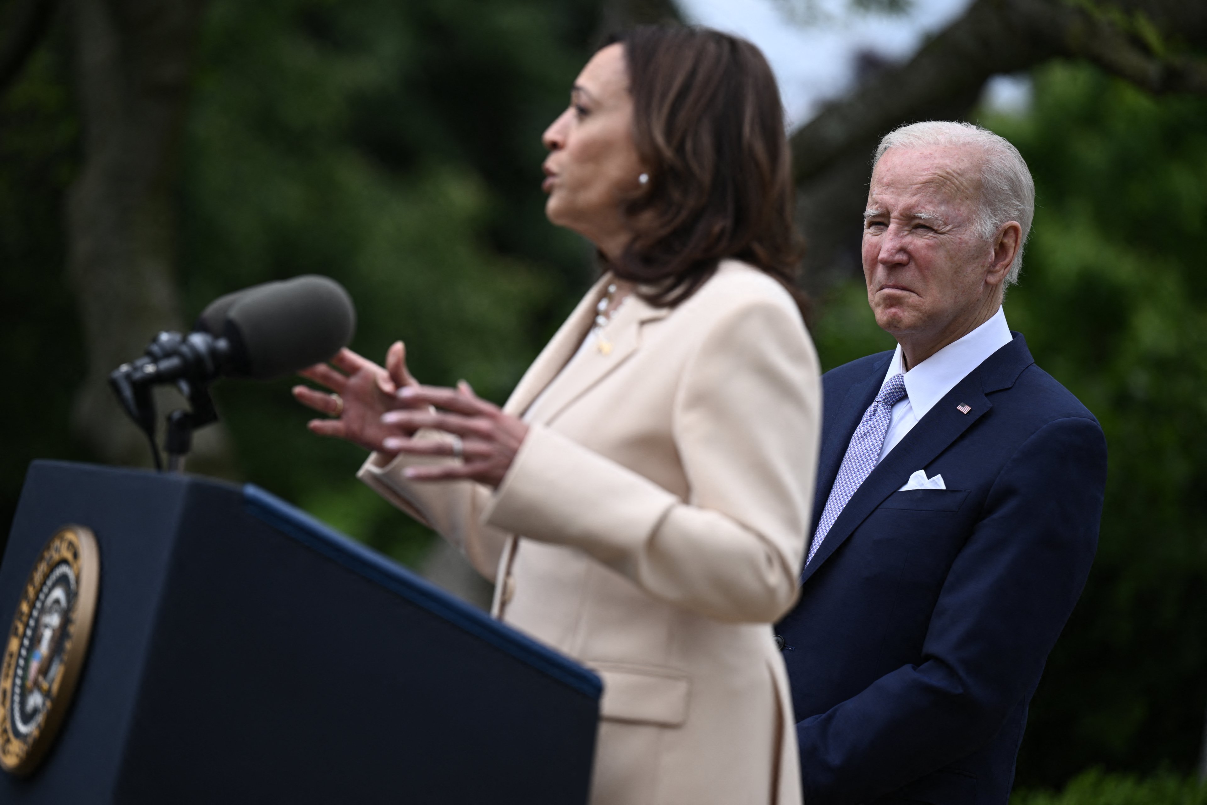(FILES) US President Joe Biden looks on as US Vice President Kamala Harris delivers remarks during National Small Business Week in the Rose Garden of the White House in Washington, DC, on May 1, 2023. Joe Biden on July 21, 2024 dropped out of the US presidential election and endorsed Vice President Kamala Harris as the Democratic Party's new nominee, in a stunning move that upends an already extraordinary 2024 race for the White House. Biden, 81, said he was acting in the "best interest of my party and the country" by bowing to weeks of pressure after a disastrous June debate against Donald Trump stoked worries about his age and mental fitness. (Photo by Brendan SMIALOWSKI / AFP)