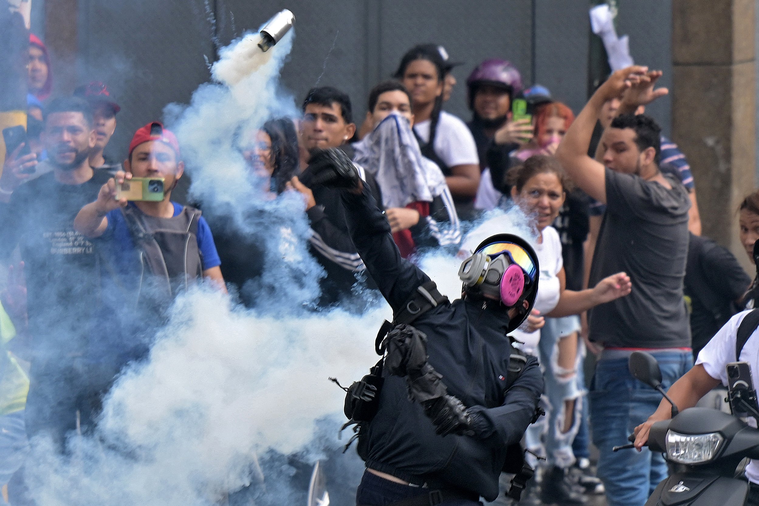 Oponentes do governo do presidente venezuelano Nicolás Maduro entram em confronto com a polícia de choque durante um protesto no bairro de Catia, em Caracas.