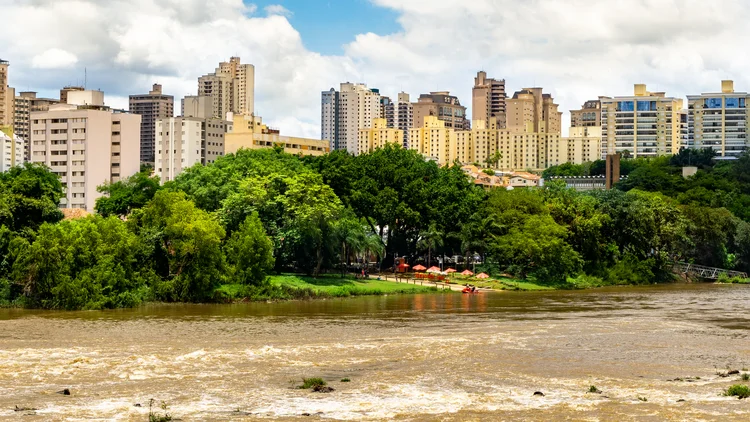 The Piracicaba River shows all its splendor with a large volume of water. In the background we see the buildings of part of downtown. Its banks are beautiful with the green of the vegetation. (Getty Images)