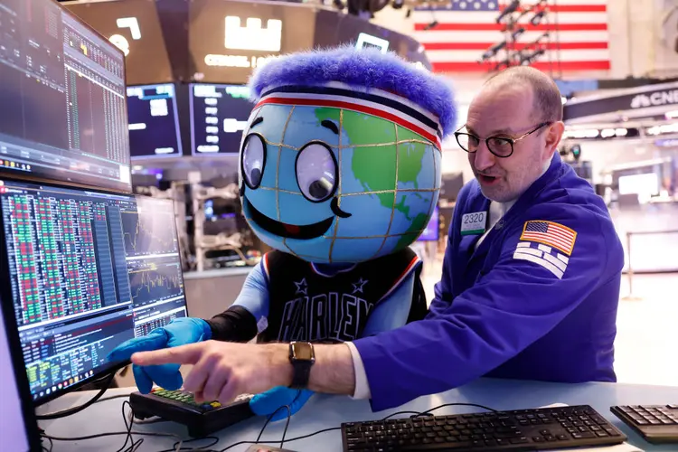 NEW YORK, NEW YORK - FEBRUARY 23: Harlem Globetrotter mascot Globey watches as trader Pete Giacchi works on the floor of the New York Stock Exchange during morning trading on February 23, 2024 in New York City. The market opened continuing its rise after yesterdays closing with the S&amp;P 500, the Nasdaq Composite posting their best day since early 2023 and the Dow Jones surpassing 39,000 for the first time ever amid Nvidia reporting a stronger-than-expected quarterly results. (Photo by Michael M. Santiago/Getty Images) (Michael M. Santiago/Getty Images)