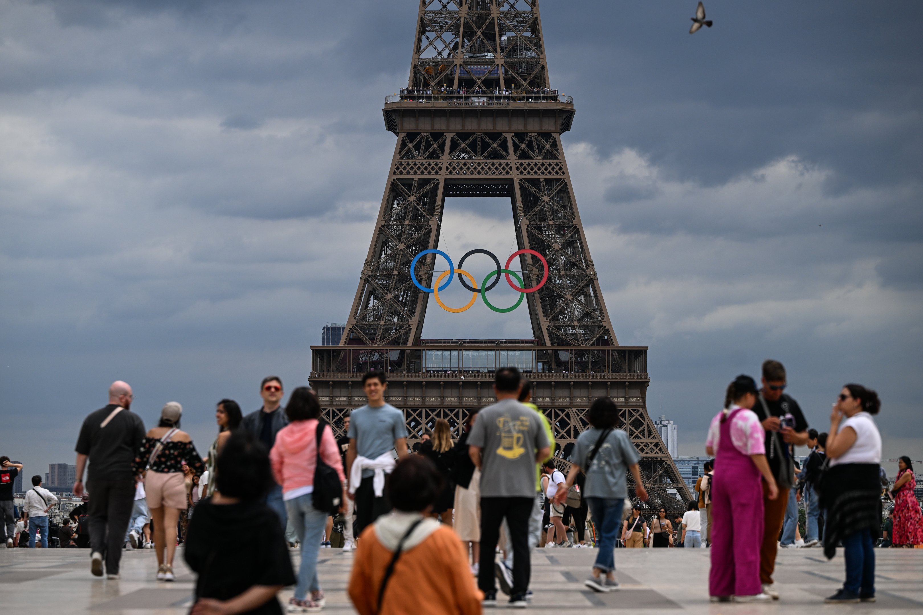 PARIS, FRANCE - JUNE 30:   
Tourists at Trocadero Plaza admire the Eiffel Tower adorned with Olympic rings, celebrating the upcoming Paris 2024 Olympic and Paralympic Games, on June 30, 2024 in Paris, France.
Paris anticipates over 11 million visitors for the XXXIII Olympic Summer Games, primarily from France, as the city prepares for the event from July 26 to August 11 (Photo by Artur Widak/NurPhoto via Getty Images)
