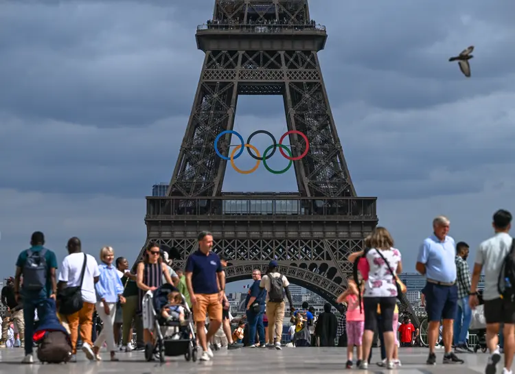 PARIS, FRANCE - JUNE 30:   
Tourists at Trocadero Plaza admire the Eiffel Tower adorned with Olympic rings, celebrating the upcoming Paris 2024 Olympic and Paralympic Games, on June 30, 2024 in Paris, France.
Paris anticipates over 11 million visitors for the XXXIII Olympic Summer Games, primarily from France, as the city prepares for the event from July 26 to August 11 (Photo by Artur Widak/NurPhoto via Getty Images) (	NurPhoto /Getty Images)
