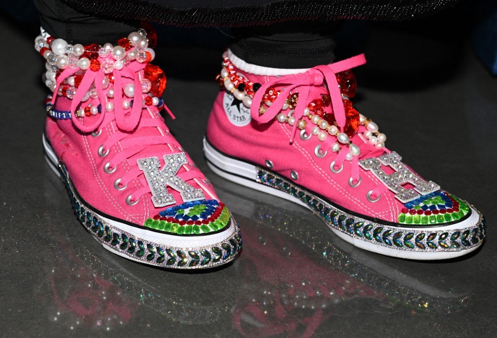 A person wears sneakers with Kamala Harris's initials on the second day of the Democratic National Convention (DNC) at the United Center in Chicago, Illinois, on August 20, 2024. Vice President Kamala Harris will formally accept the partys nomination for president at the DNC which runs from August 19-22 in Chicago. (Photo by Robyn Beck / AFP)