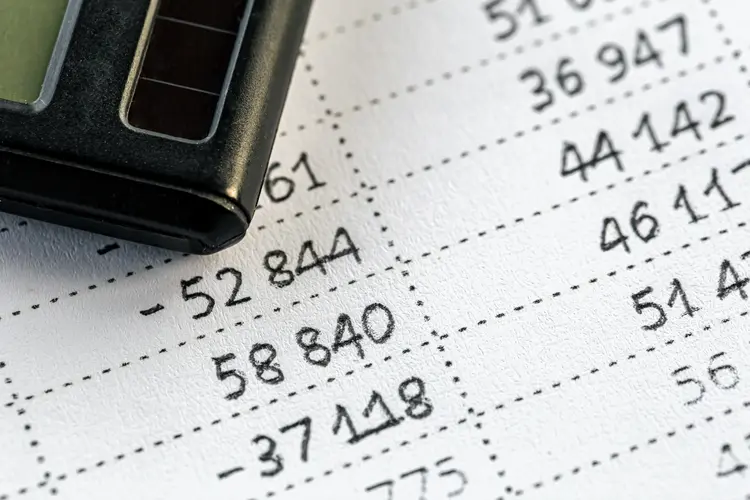 Calculator and numbers on paper close-up, the concept of budget planning, making money, tax calculations.