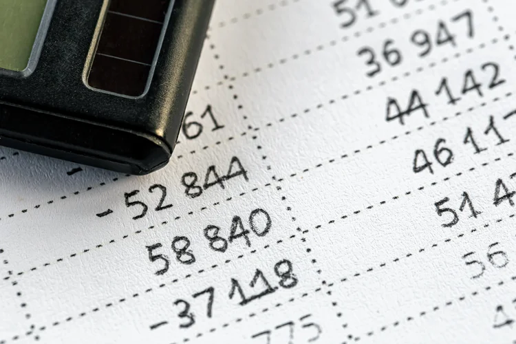 Calculator and numbers on paper close-up, the concept of budget planning, making money, tax calculations.