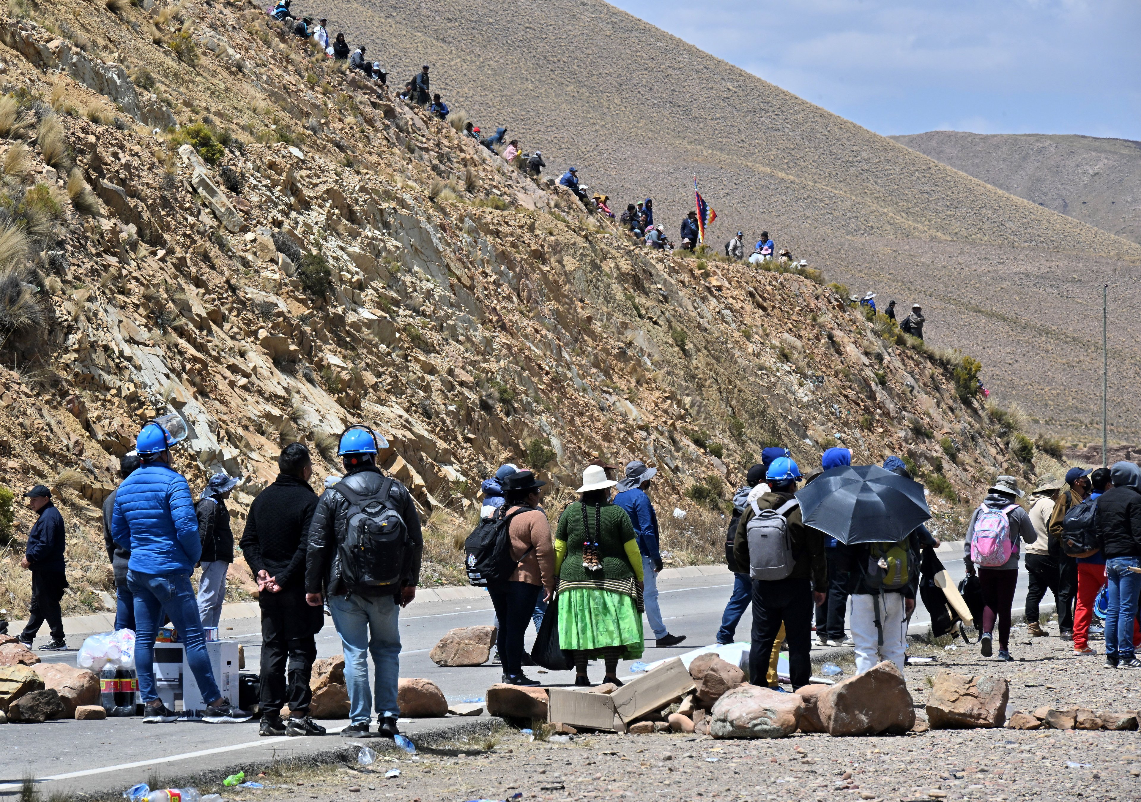 Supporters of Bolivia's Luis Arce block the road near Vila Vila, province of Oruro, 180 km south of La Paz, Bolivia, while attempting to stop the so-called March to Save Bolivia called by former president Evo Morales on September 17, 2024. Former president Evo Morales, who accuses president Luis Arce of using the judiciary and electoral powers to block his presidential candidacy, began a march to La Paz along several thousand of his supporters, while the government insisted on conspiratorial efforts. (Photo by AIZAR RALDES / AFP)