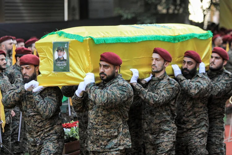 Fighters of the Lebanese Shiite movement Hezbollah carry the body of the group's top military commander Ibrahim Aqil during his funeral in Beirut's southern suburbs on September 22, 2024. Ibrahim Aqil and other commanders of Hezbollah's "Radwan Force" were killed in an Israeli air strike on September 20. Hezbollah's most formidable offensive force, Radwan fighters have spearhead the movement's ground operations and its units regularly target northern Israel. (Photo by AFP) (AFP)