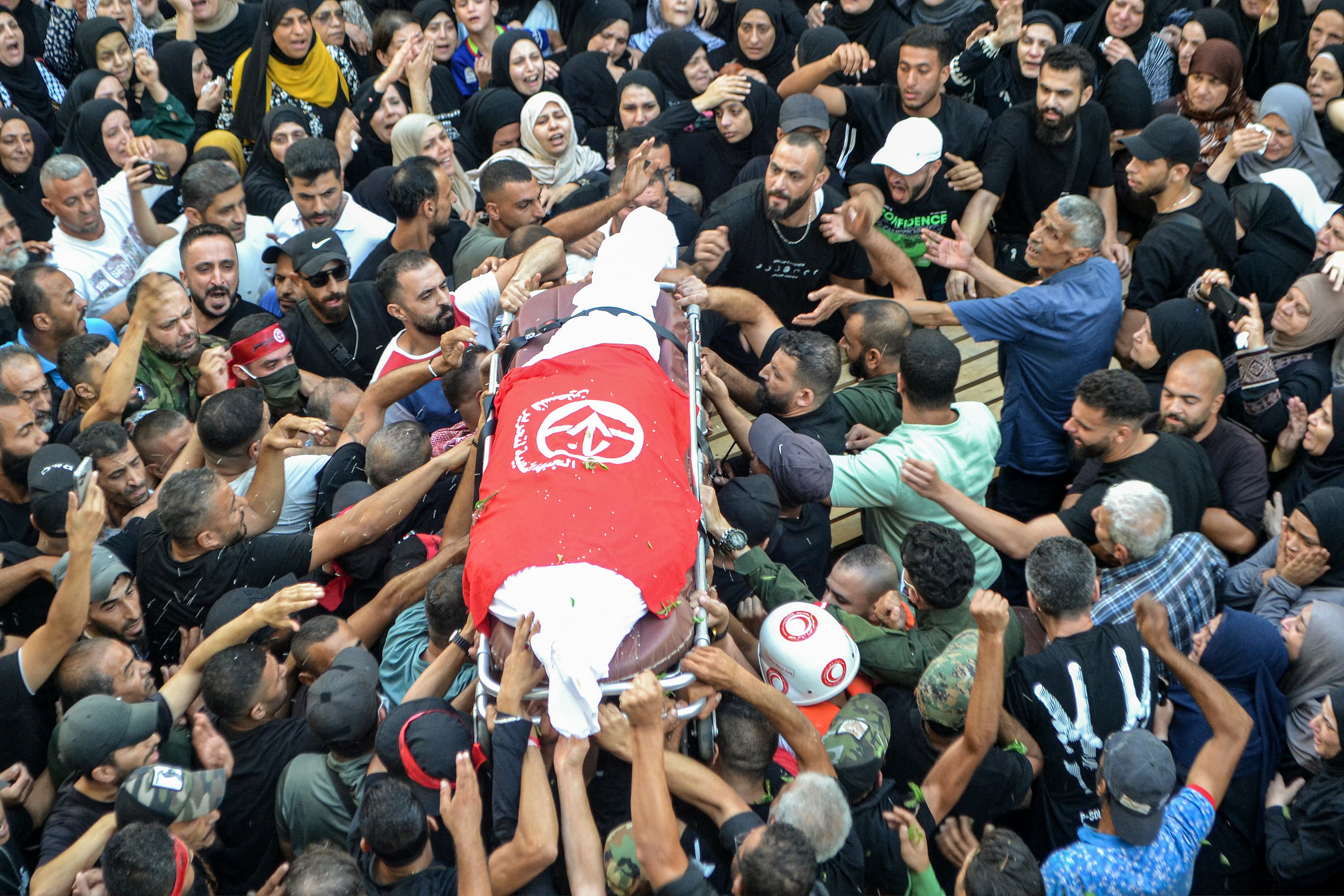 Mourners in the Nahr al-Bared camp for Palestinian refugees gather for the funeral of commanders of the Popular Front For the Liberation of Palestine (PFLP) group who were killed by an overnight Israeli air strike in Beirut, at the camp near Lebanon's northern city of Tripoli on September 30, 2024. (Photo by Fathi AL-MASRI / AFP)