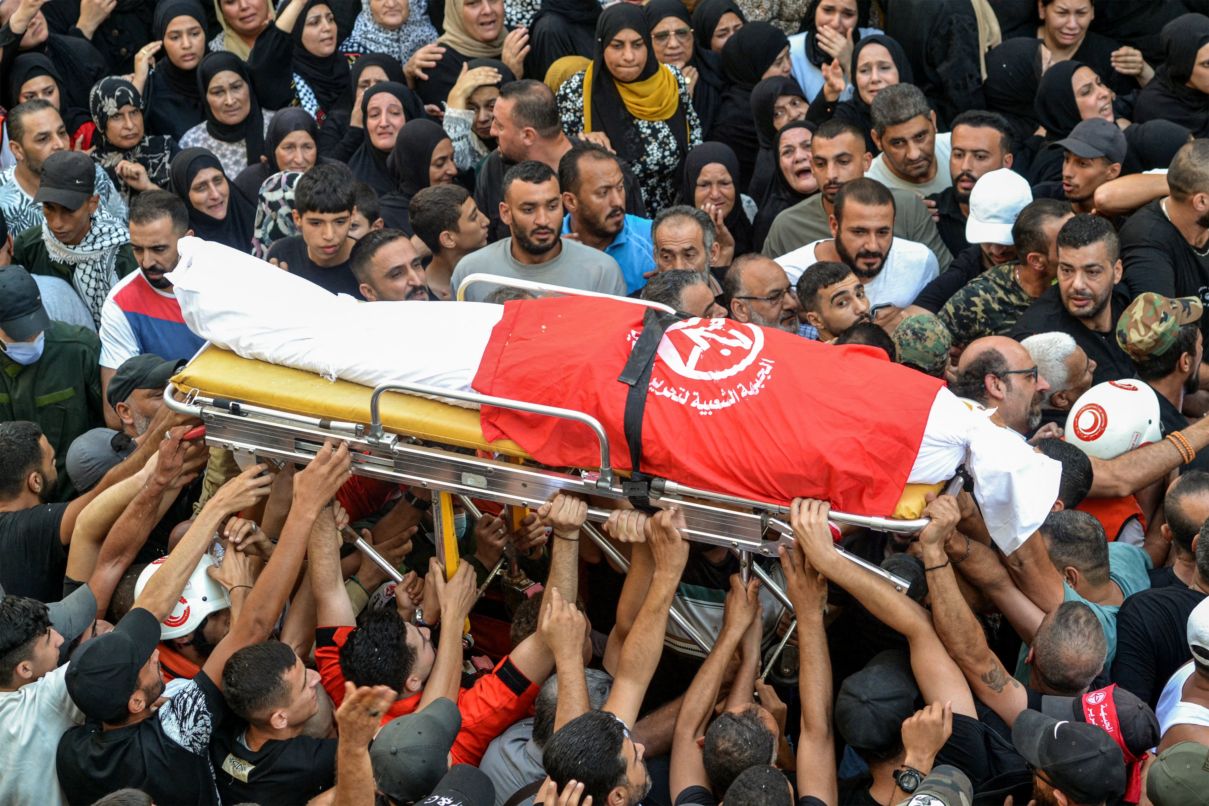 Mourners in the Nahr al-Bared camp for Palestinian refugees gather for the funeral of commanders of the Popular Front For the Liberation of Palestine (PFLP) group who were killed by an overnight Israeli air strike in Beirut, at the camp near Lebanon's northern city of Tripoli on September 30, 2024. (Photo by Fathi AL-MASRI / AFP)