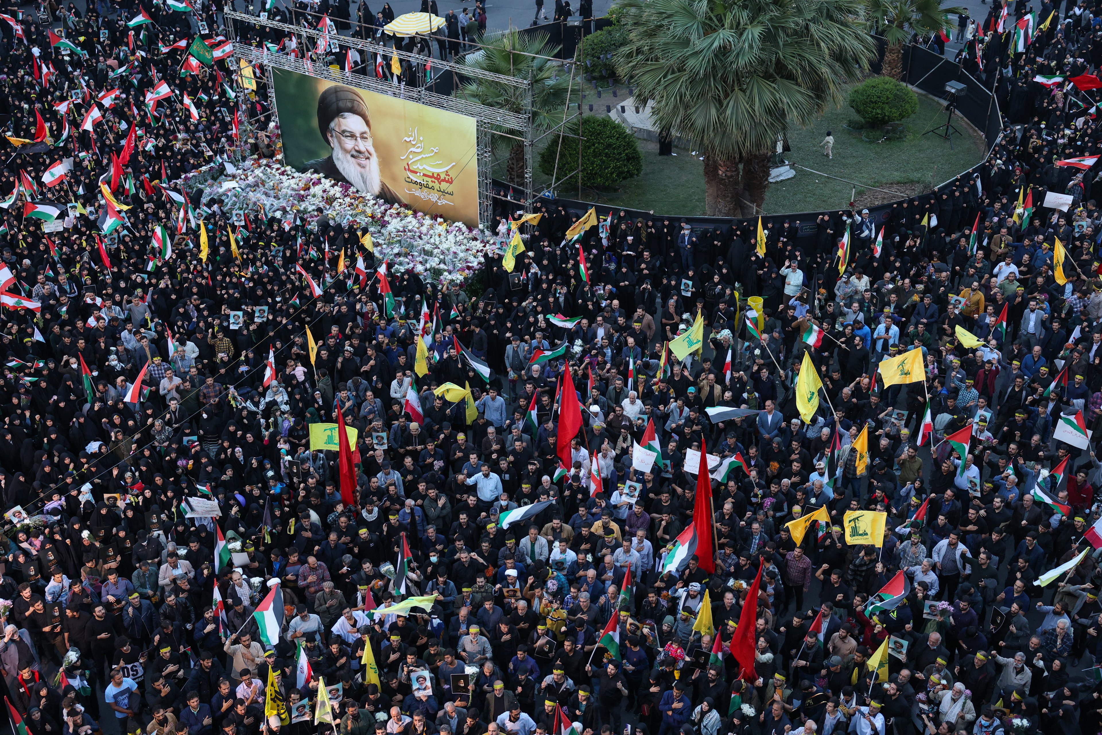 Iranians hold pictures of Hezbollah leader Hassan Nasrallah, who was killed in an Israeli air strike on Beirut's southern suburbs on September 27, during an anti-Israel protest in Palestine Square in Tehran on September 30, 2024. (Photo by ATTA KENARE / AFP)