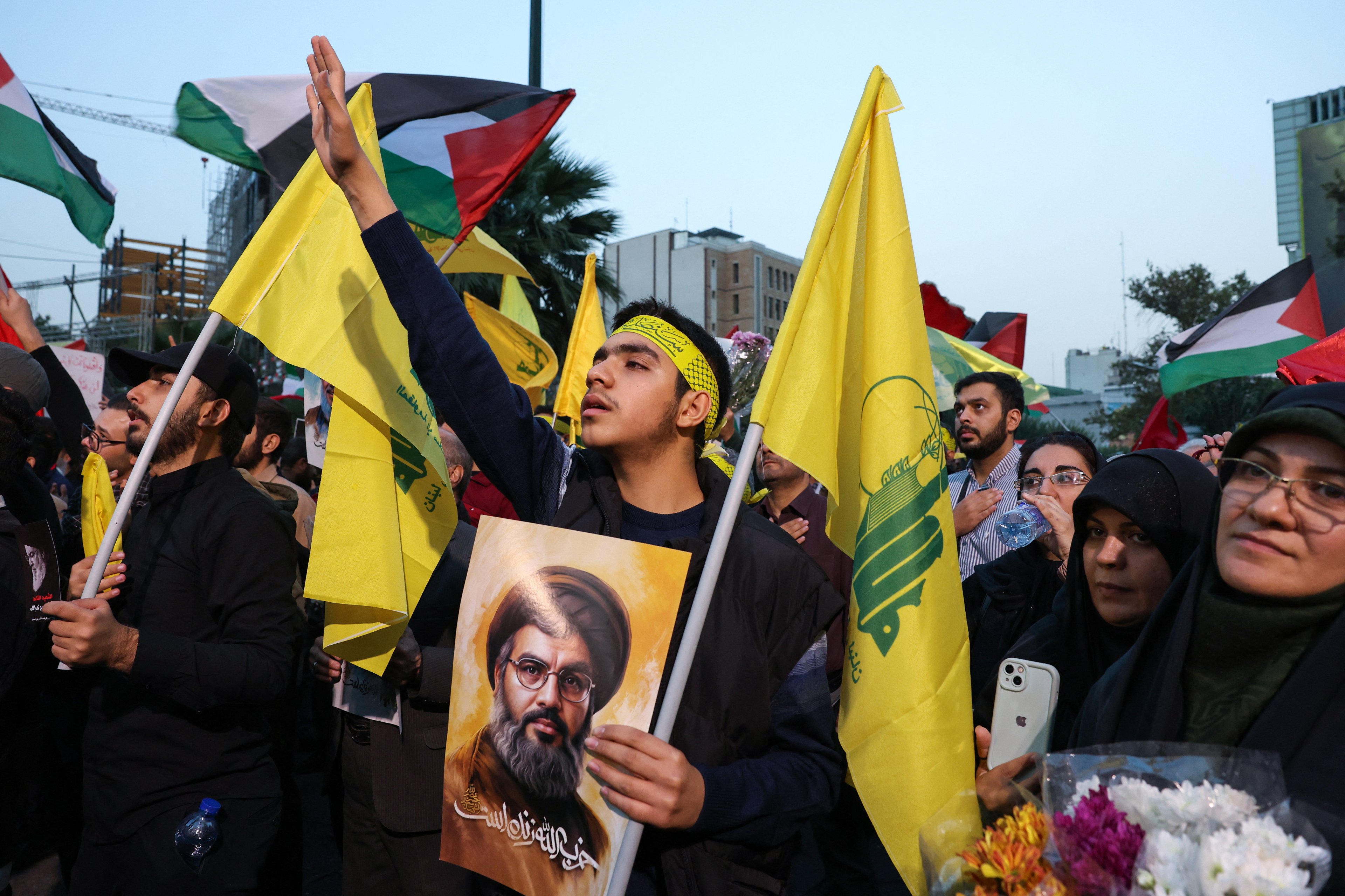 Iranians hold pictures of Hezbollah leader Hassan Nasrallah, who was killed in an Israeli air strike on Beirut's southern suburbs on September 27, during an anti-Israel protest in Palestine Square in Tehran on September 30, 2024. (Photo by ATTA KENARE / AFP)