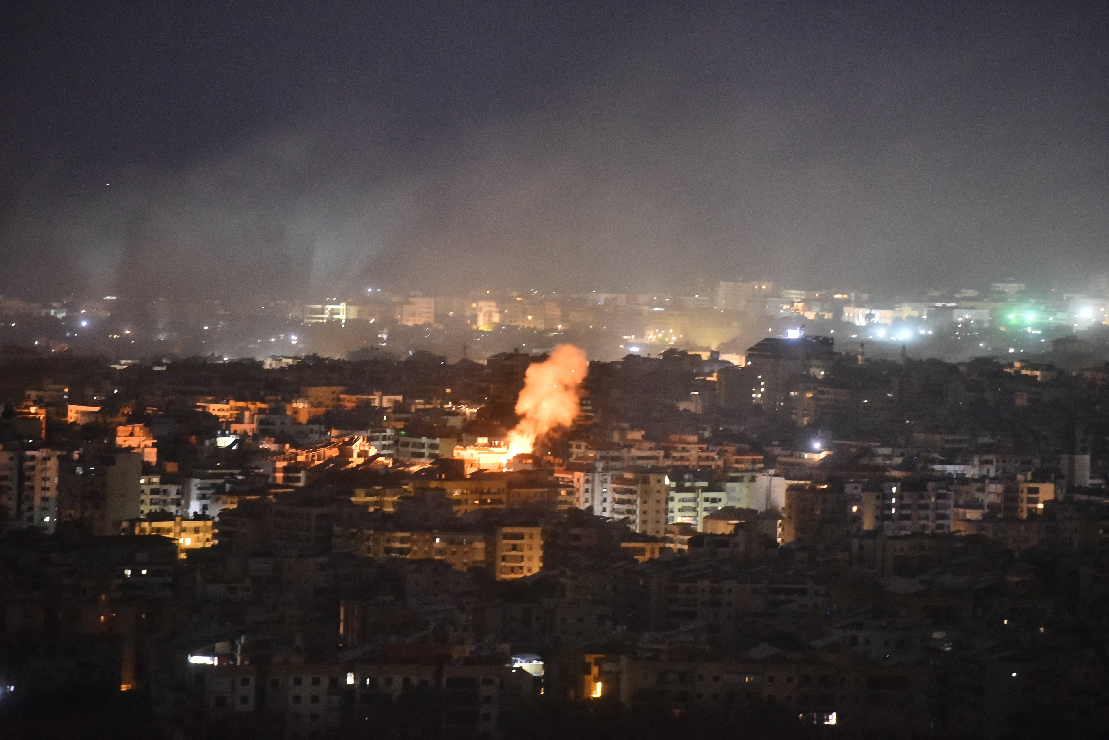 Smoke rises from the site of an Israeli airstrike that targeted a neighborhood in Beiruts southern suburb early on October 1, 2024. The Israeli military said Tuesday troops have started "targeted ground raids" in villages of southern Lebanon. The incursions backed by airstrikes and artillery began "a few hours ago" and are targeting militant group Hezbollah "in villages close to the border" with Israel, a military statement said. (Photo by Fadel ITANI / AFP)