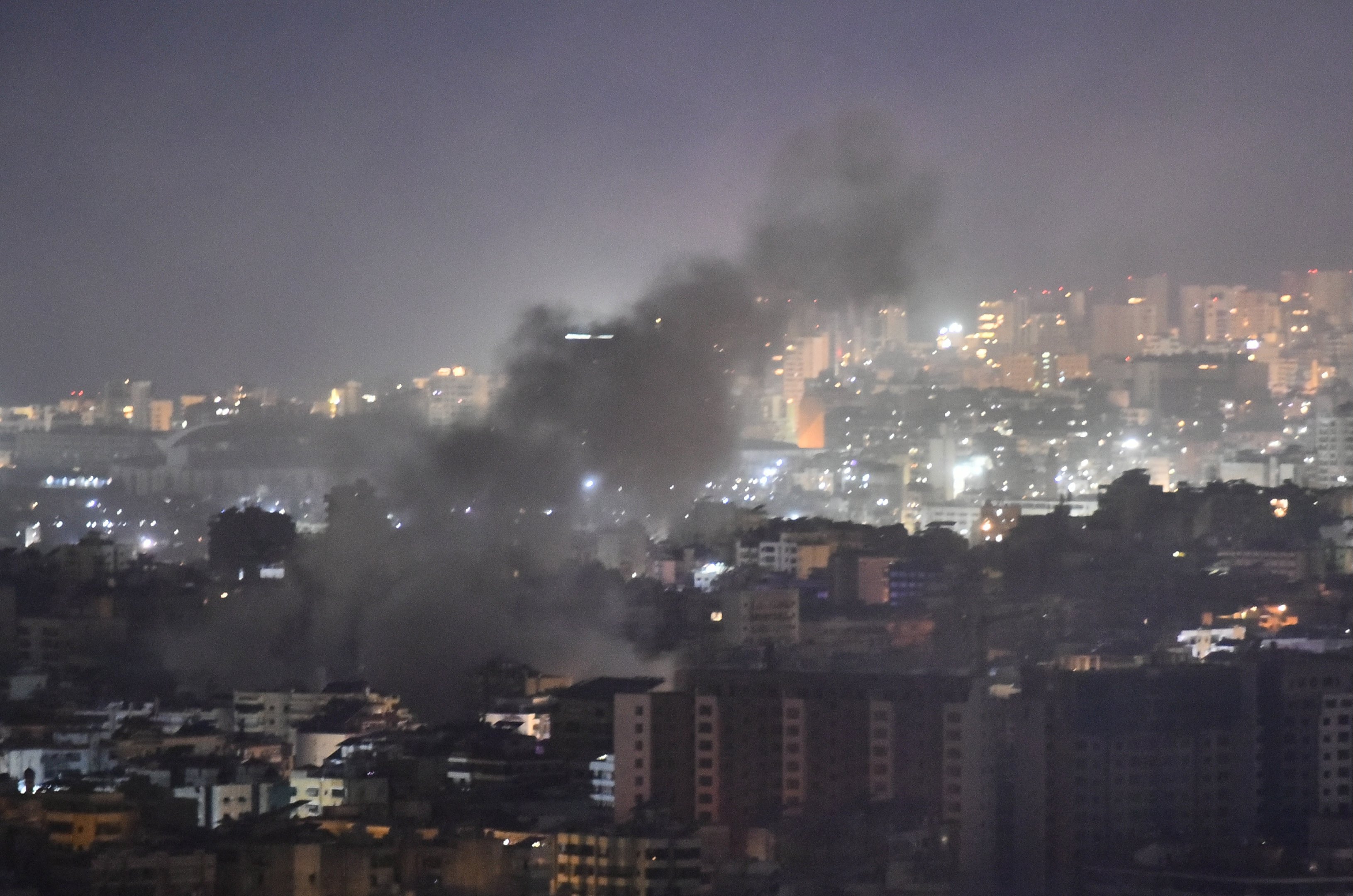 Smoke rises from the site of an Israeli airstrike that targeted a neighborhood in Beiruts southern suburb early on October 1, 2024. The Israeli military said Tuesday troops have started "targeted ground raids" in villages of southern Lebanon. The incursions backed by airstrikes and artillery began "a few hours ago" and are targeting militant group Hezbollah "in villages close to the border" with Israel, a military statement said. (Photo by Fadel ITANI / AFP)