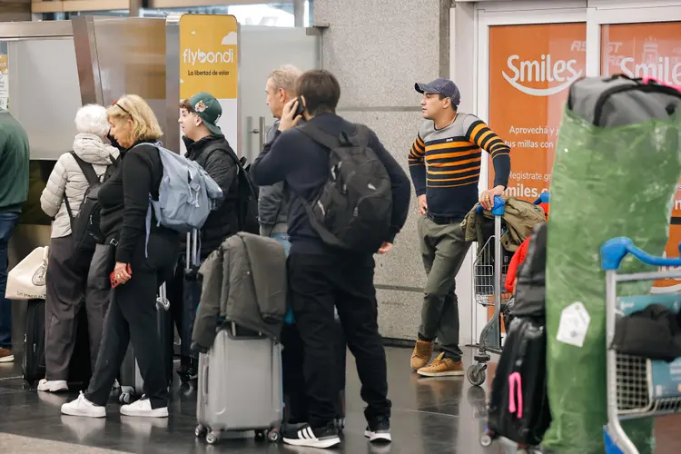 Passageiros fazem fila em frente ao balcão de informações da Aerolíneas Argentinas durante a greve de pilotos e tripulantes (Juan Ignacio Roncoroni/EFE)