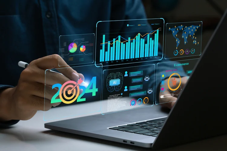 Businessman works on laptop Showing 2024 business trends dashboard with charts, metrics,  AI, E-commerce, KPI. analytical businessperson planning business growth 2024. New Year Future business tech. (pcess609/Getty Images)