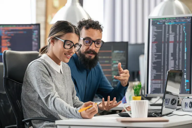 Software programmers analyzing html code and database, brainstorming script ideas to develop new security system. Engineers working with coding language collaborating on group project (valentinrussanov/Getty Images)