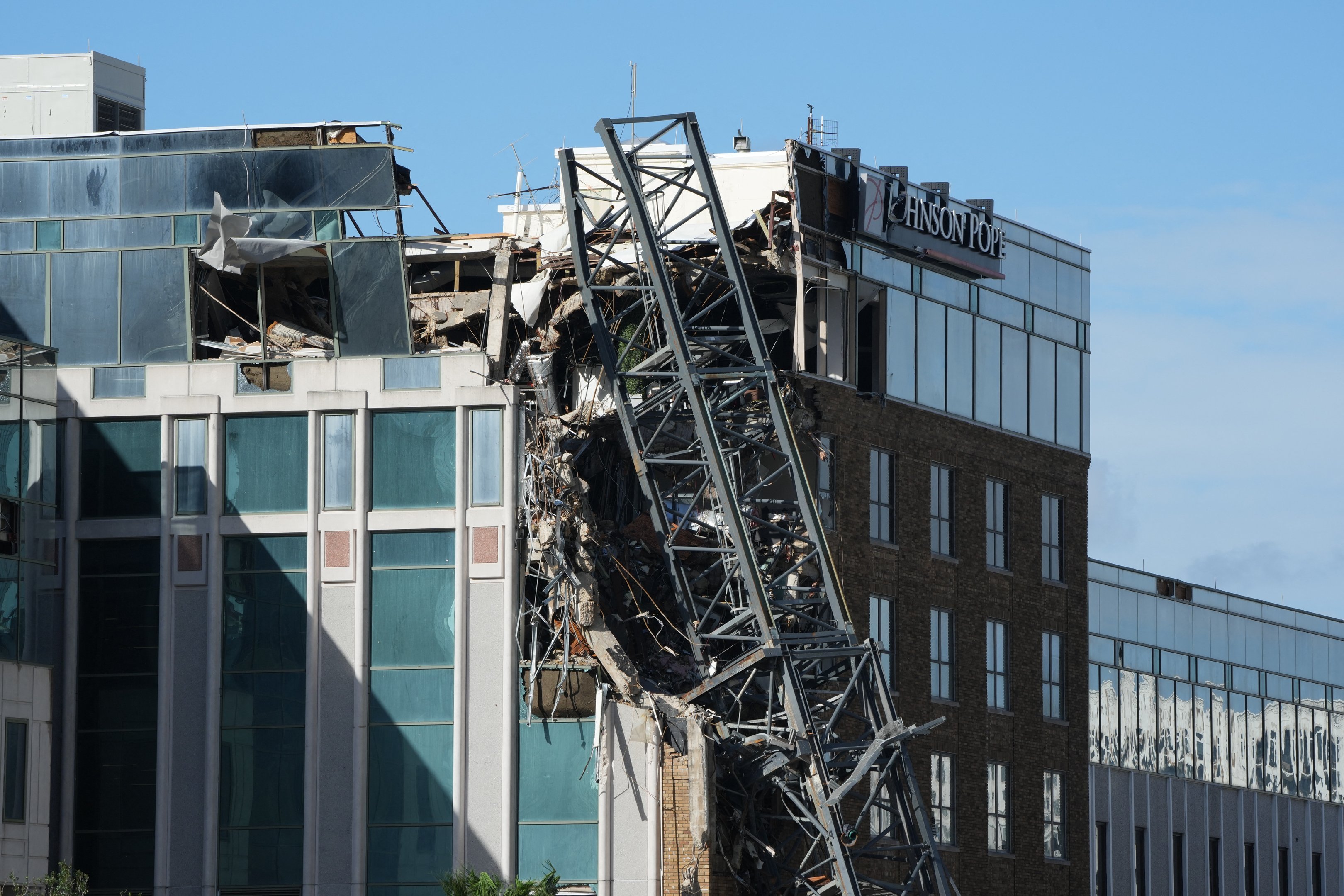 A crane that collapsed into a building is seen in downtown St. Petersburg due to Hurricane Milton on October 10, 2024 in Florida. At least four people were confirmed killed as a result of two tornadoes triggered by Hurricane Milton on the east coast of the US state of Florida, local authorities said Thursday. (Photo by Bryan R. SMITH / AFP)