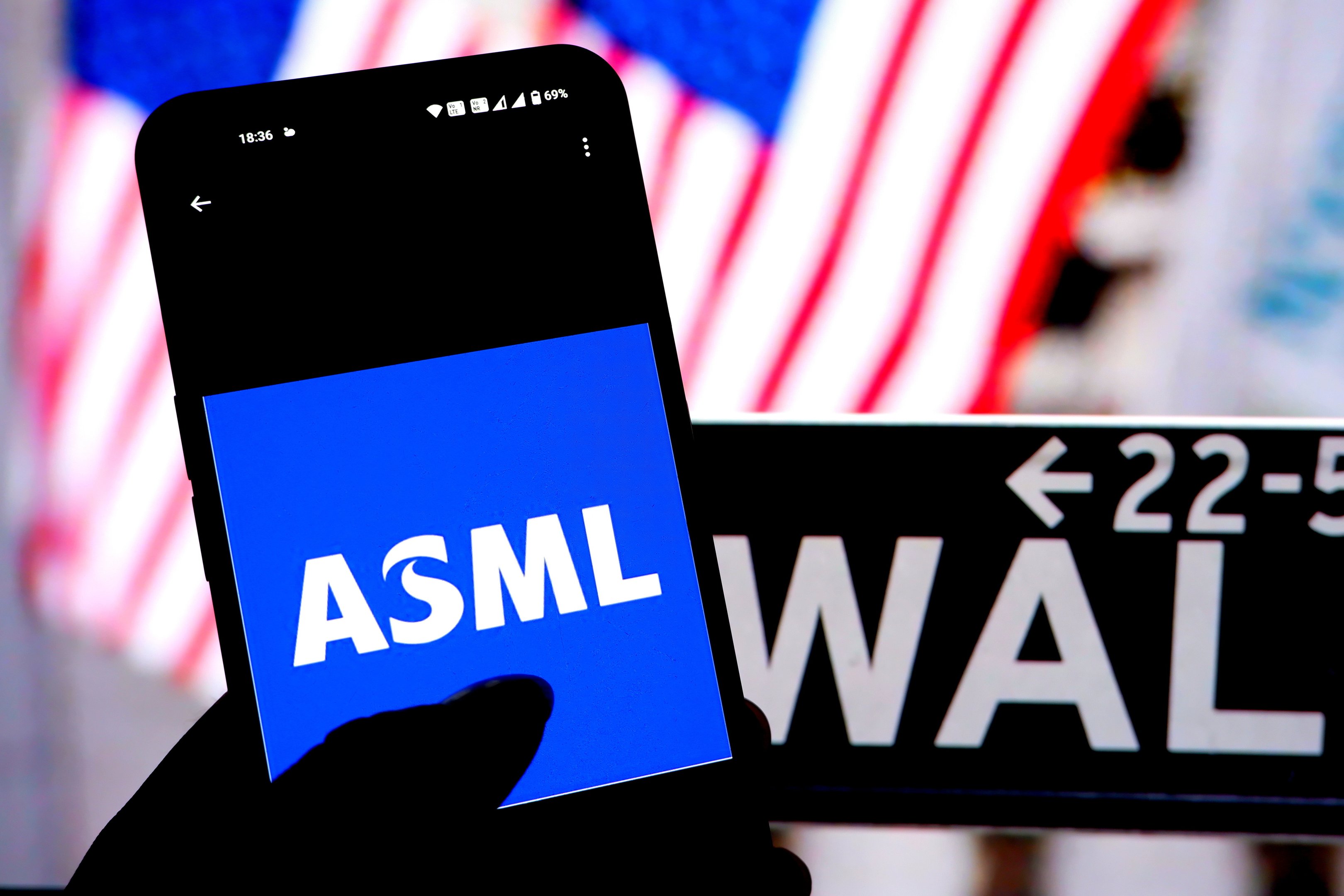 INDIA - 2024/04/07: In this photo illustration, an ASML Logo seen displayed on a smartphone with the Wall Street - New York Stock Exchange logo in the background. (Photo Illustration by Avishek Das/SOPA Images/LightRocket via Getty Images)