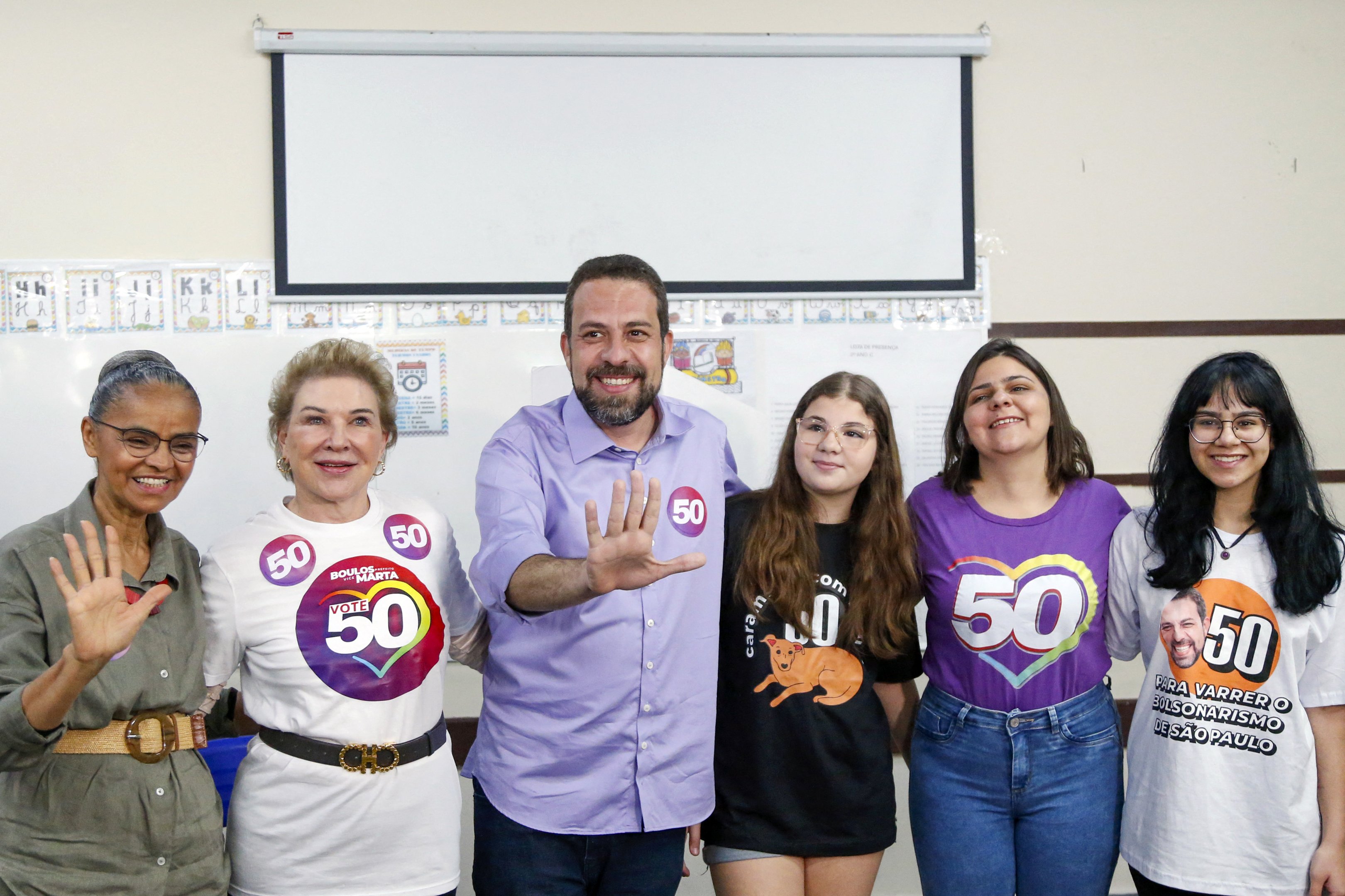 Sao Paulo city mayoral candidate Guilherme Boulos, for the Socialismo e Liberdade party (PSOL), gestures next to Brazilian Minister of Environment Marina Silva (L), his vice mayor candidate Marta Suplicy (2nd L), his wife Natalia Szermeta (2nd R) and their daughters Laura and Sofia (R) while casting his vote during the municipal elections first round, in Sao Paulo, Brazil, on October 6, 2024. Brazilians go to the polls Sunday to elect mayors and councillors in more than 5,500 cities after a vitriolic, sometimes violent campaign two years after presidential elections that polarized Latin America's biggest country. (Photo by Miguel SCHINCARIOL / AFP) (Photo by MIGUEL SCHINCARIOL/AFP via Getty Images)