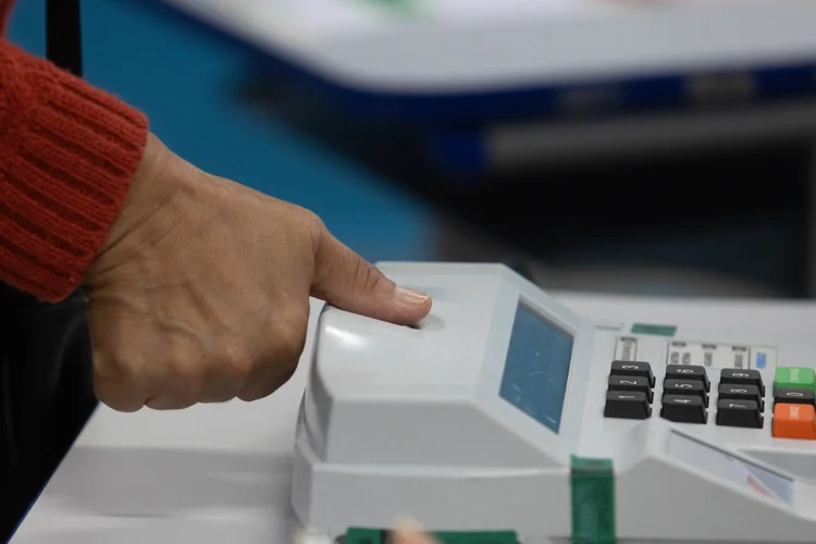 A woman places her thumb for fingerprint identification during the municipal elections first round, in Sao Paulo, Brazil, on October 6, 2024. Brazilians go to the polls Sunday to elect mayors and councillors in more than 5,500 cities after a vitriolic, sometimes violent campaign two years after presidential elections that polarized Latin America's biggest country. (Photo by Nilton Fukuda / AFP) (Photo by NILTON FUKUDA/AFP via Getty Images) (NILTON FUKUDA/AFP)