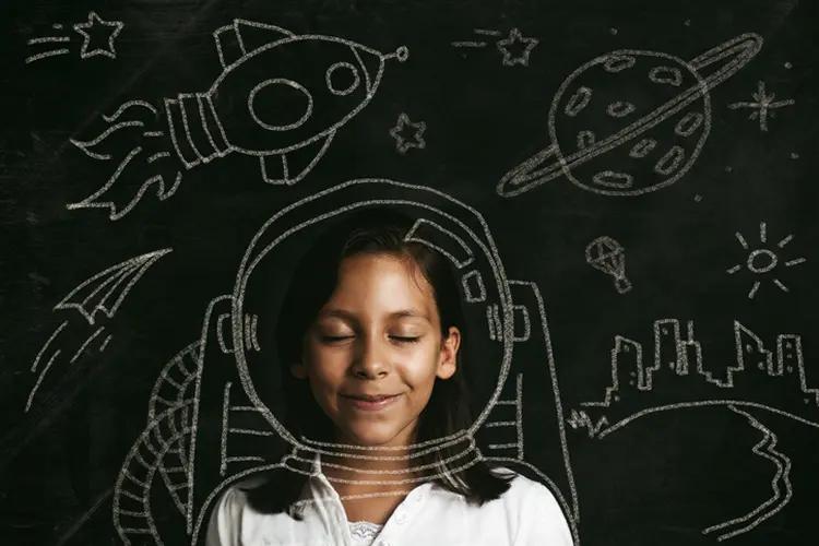 Young girl dreaming of flying to space. Illustrative concept. (Marilyn Nieves/Getty Images)