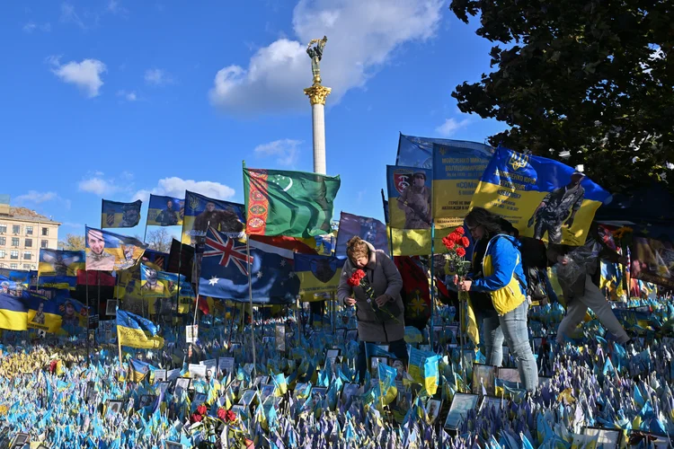 Women lay flowers in tribute to fallen Ukrainian soldiers at a makeshift memorial at Independence Square in Kyiv, on November 2, 2024, amid the Russian invasion in Ukraine. (Photo by Sergei SUPINSKY / AFP) (Sergei SUPINSKY/AFP)