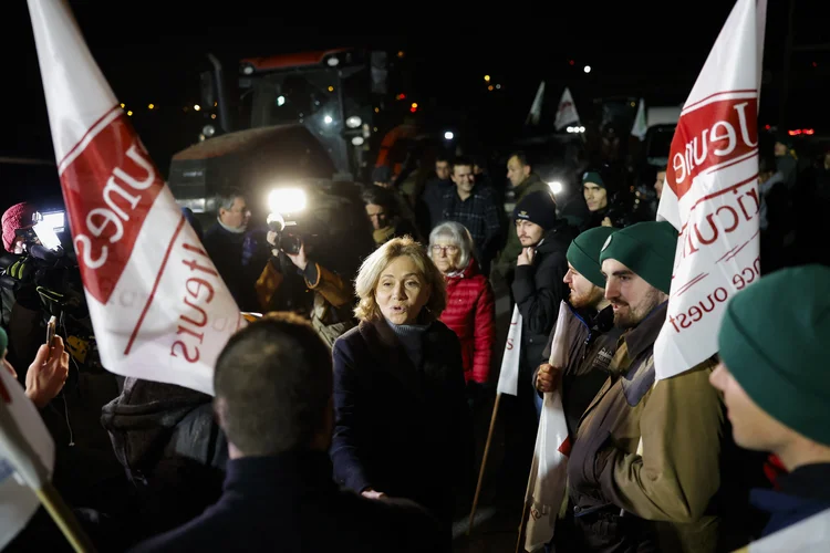 A presidente do conselho regional de Ile-de-France, Valerie Pecresse (C), se reúne com fazendeiros franceses na estrada RN118 no início de um protesto nacional contra o acordo UE-Mercosul (Ian LANGSDON/AFP)