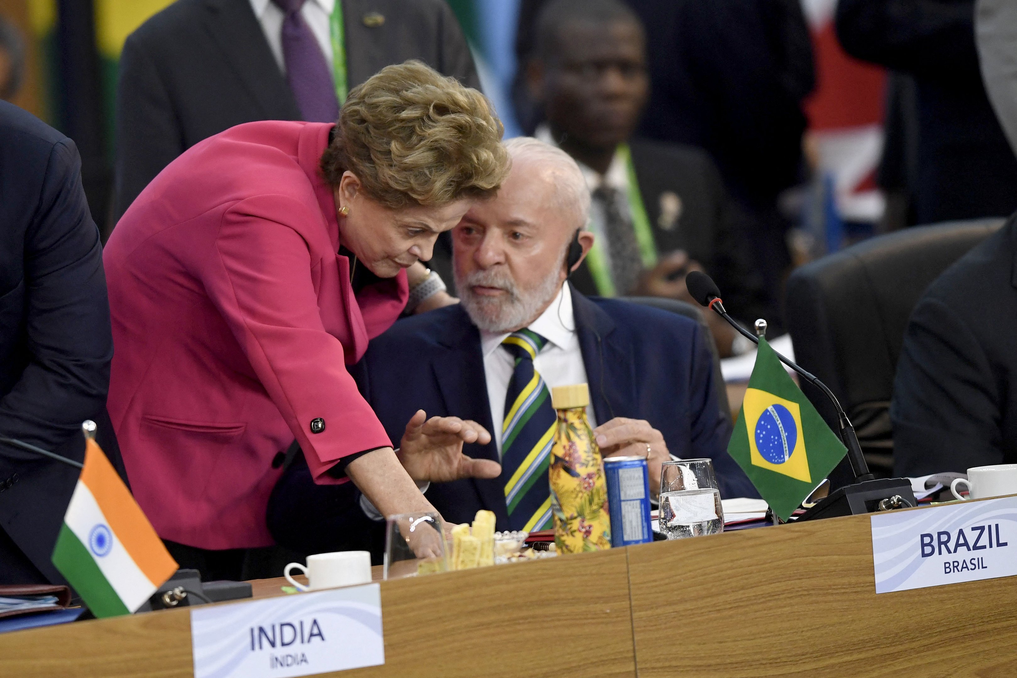 Brazil's President Luiz Inacio Lula da Silva (R) speaks with the president of the New Development Bank (NDB), Brazil's Dilma Rousseff during the G20 Summit opening session in Rio de Janeiro, Brazil, on November 18, 2024