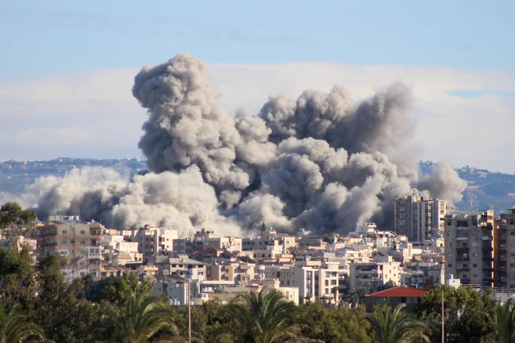 Uma foto tirada da cidade costeira de Tiro, no sul do Líbano, mostra fumaça subindo após um ataque aéreo israelense que teve como alvo a área de al-Hawsh, nos arredores da cidade costeira, em 26 de novembro de 2024 (KAWNAT HAJU/AFP)