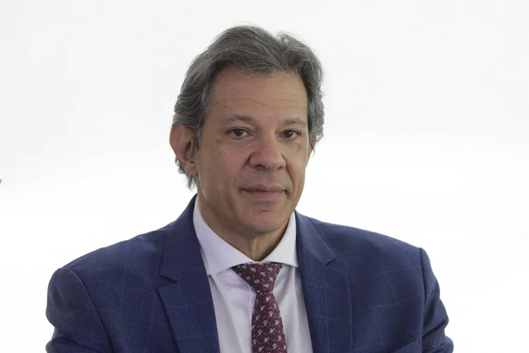 Brazil's Economy Minister Fernando Haddad looks on next to Brazil's President Luiz Inacio Lula da Silva (out of frame) during a meeting on family farming at the Planalto Palace in Brasilia on November 27, 2024. (Photo by Sergio Lima / AFP)