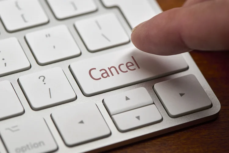 A finger about to press a "Cancel" button on a computer keyboard.  Cape Town, South Africa, May 2021. (David Malan/Getty Images)