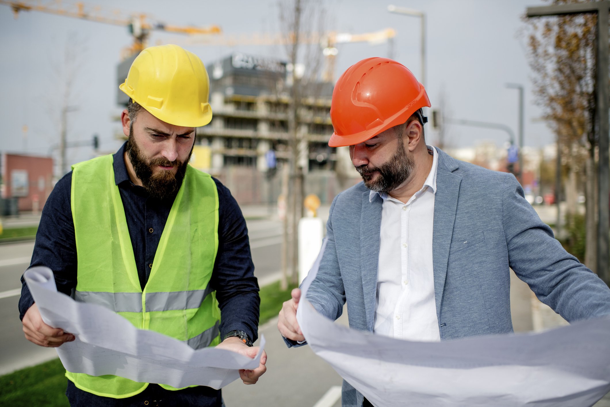 Architect and construction worker having work meeting at construction site