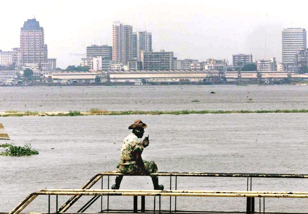 A Congolese soldier looks at the Democratic Republic of Congo (DRC) capital, Kinshasa, 20 August at the Brazzaville port. As rebel forces close in on Kinshasa, French nationals and others expatriates continued to flee the DRC, crossing the Congo river on barges to take refuge here in the Congolese capital. Four of five boats are making daily crossings from Kinshasa to Brazzaville, which it faces over the river.  (ELECTRONIC IMAGE) (Photo by JEAN-PHILIPPE KSIAZEK / AFP) (Photo by JEAN-PHILIPPE KSIAZEK/AFP via Getty Images)