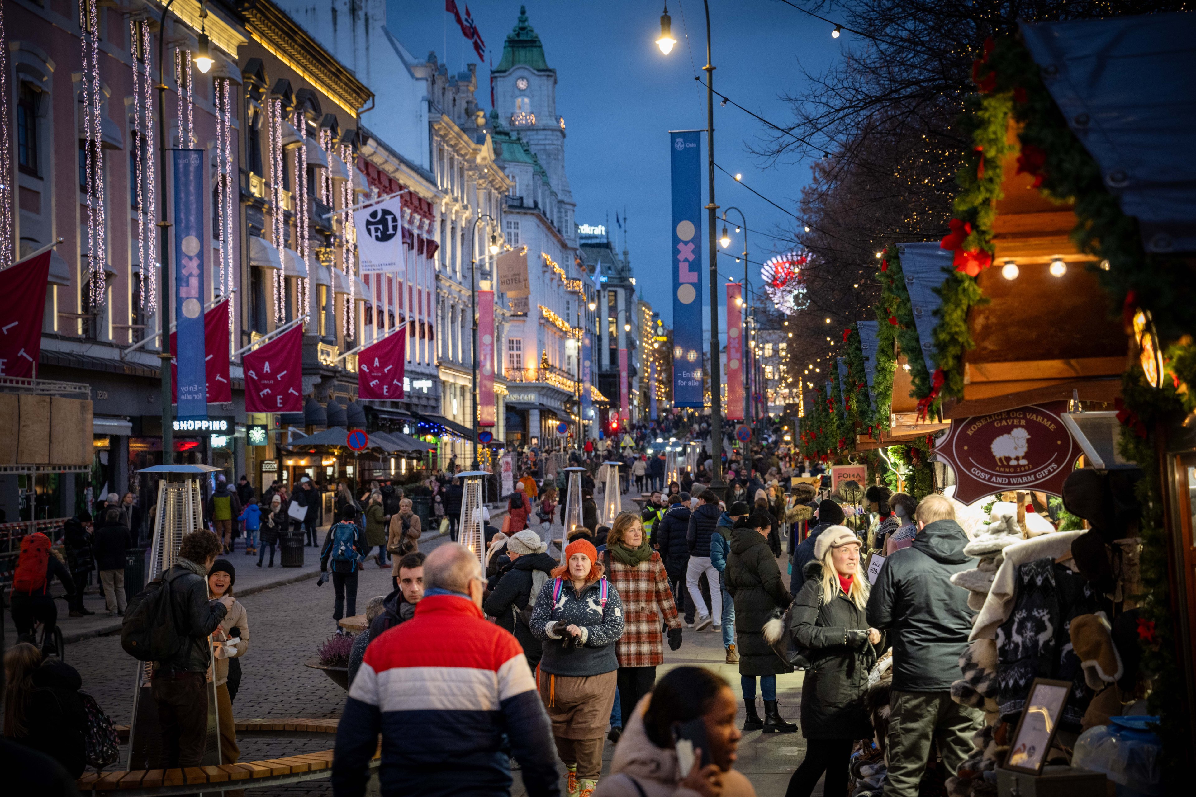 People are walking near a Christmas fair in the Karl Johans Gate area near downtown Oslo, Norway, on November 17, 2023. (Photo by Jorge Mantilla/NurPhoto via Getty Images)