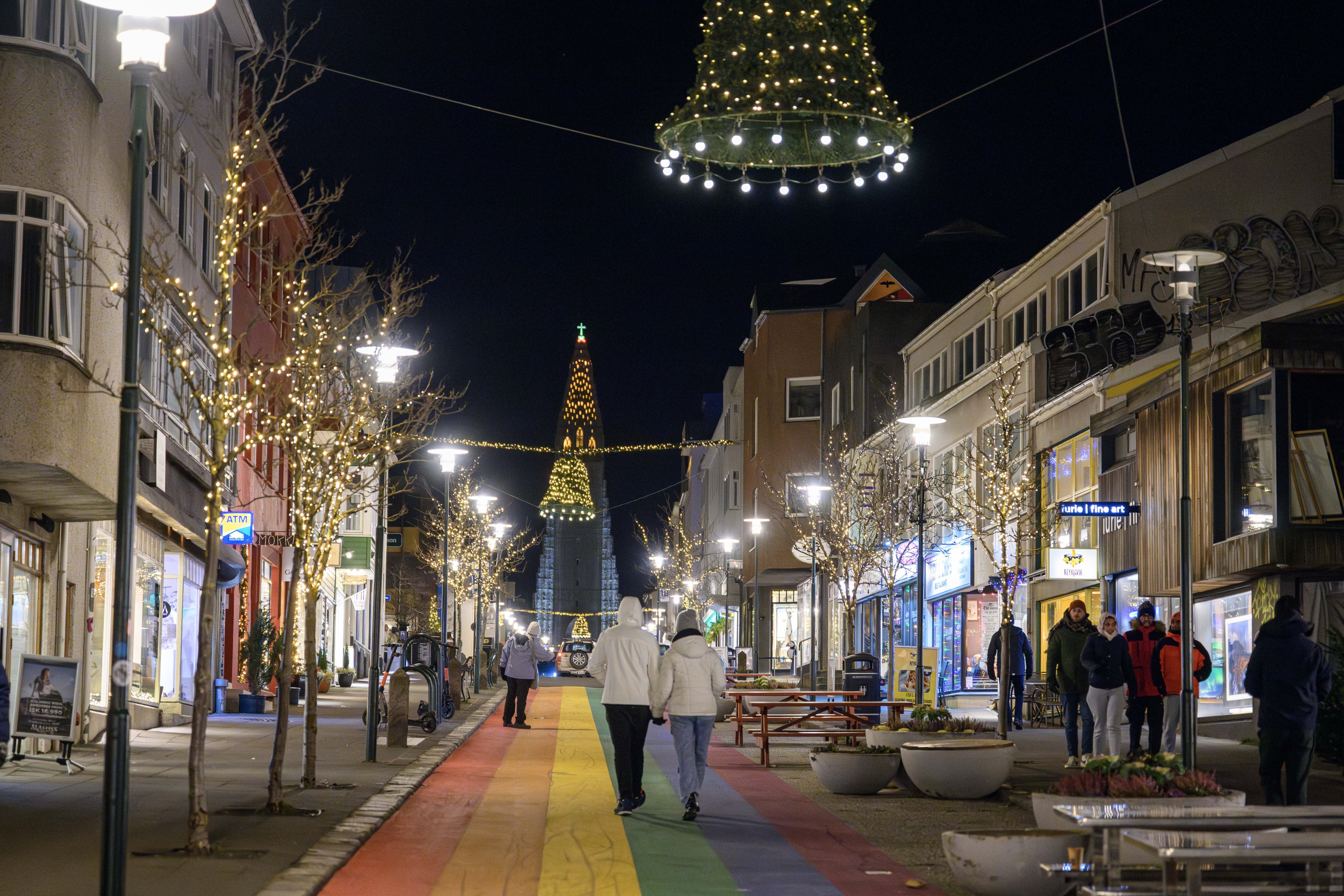 Several people walk along Skolavordustigur street in downtown Reykjavik, Iceland, on November 23, 2024