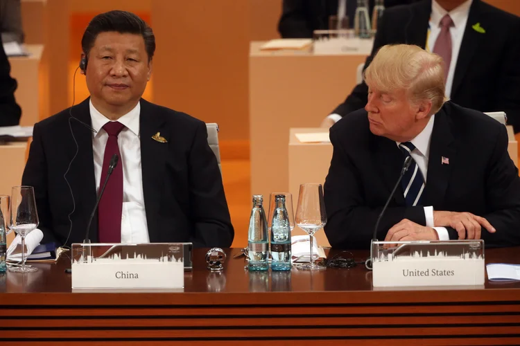 O presidente dos EUA, Donald Trump (D), olha para o presidente chinês, Xi Jinping, durante a sessão plenária na Cúpula do G20 em 7 de julho de 2017 em Hamburgo, Alemanha (Mikhail Svetlov/Getty Images)